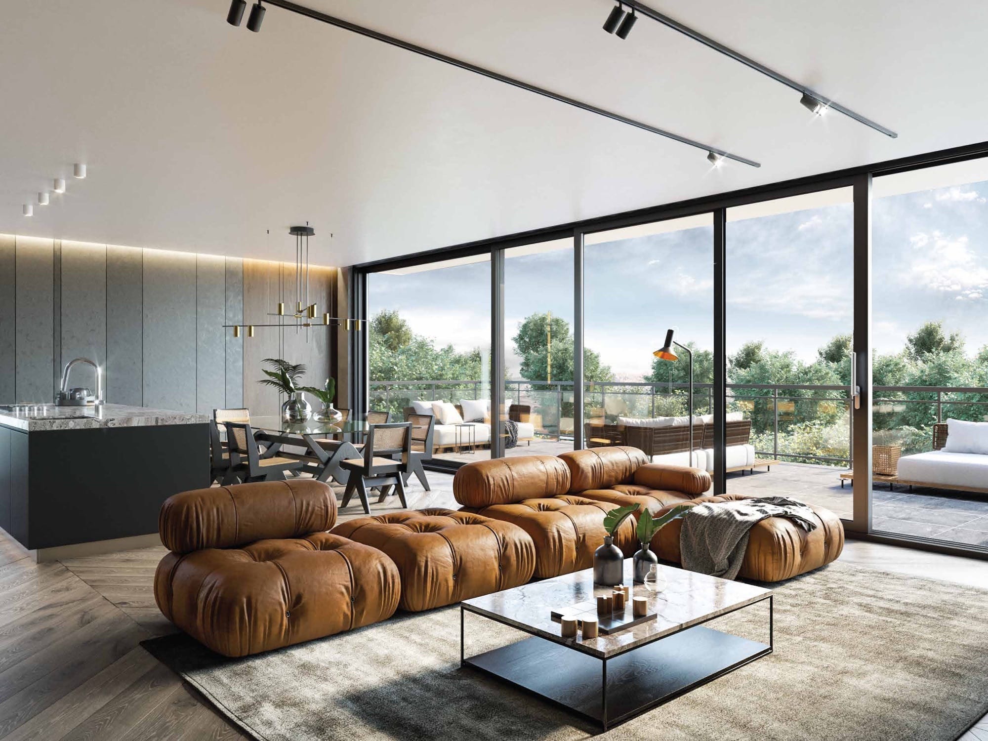 Salon avec canapé en cuir et grande porte levante coulissante ouverte sur une terrasse avec vue sur les montagnes