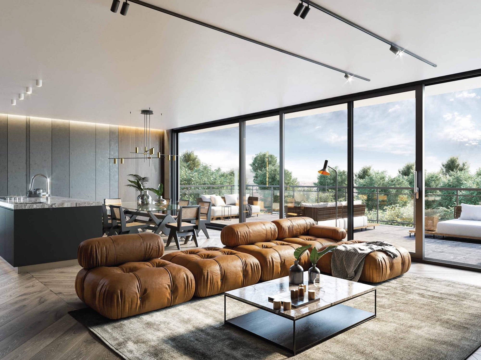 Living room with a leather sofa and a large lift-and-slide door open onto a terrace with mountain views