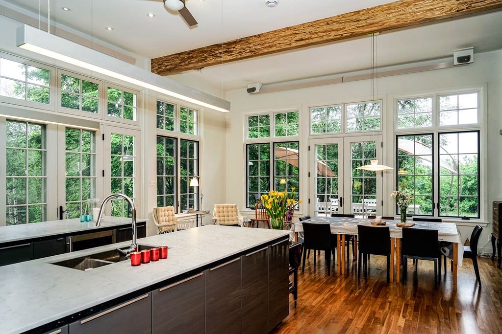 White casement windows in a kitchen with island and beams