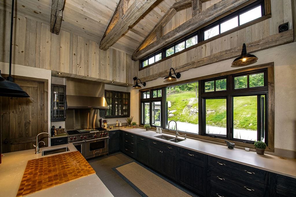 Black casement windows in a kitchen with a high wood ceiling