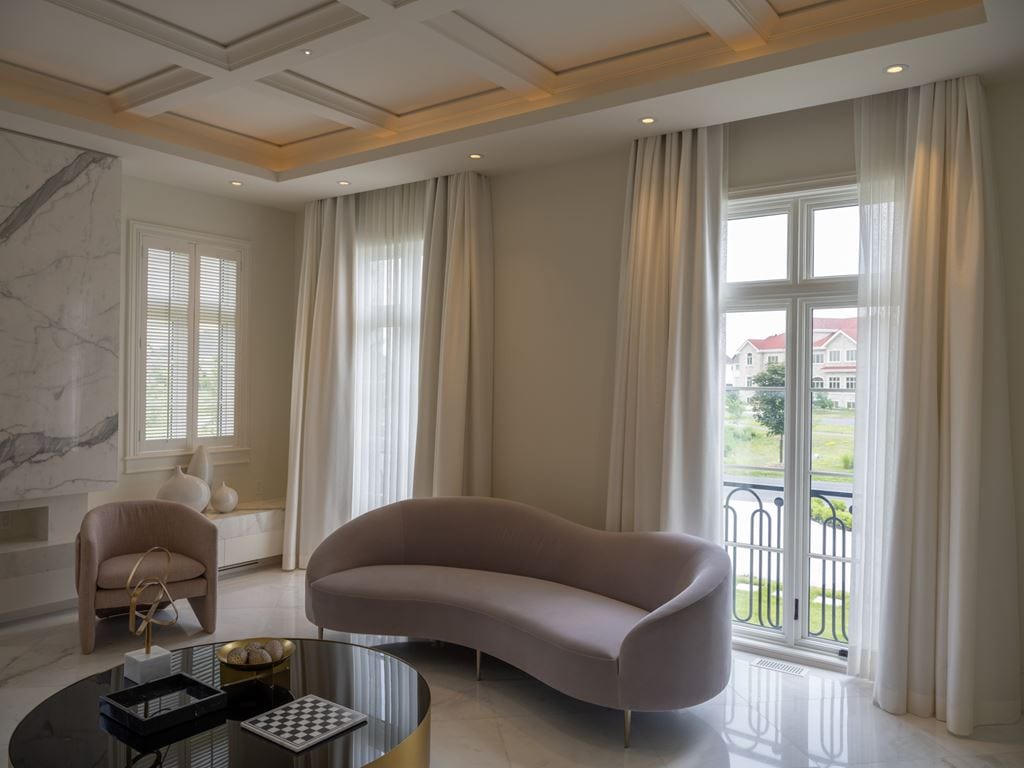 White casement windows and curtains in a minimalist living room