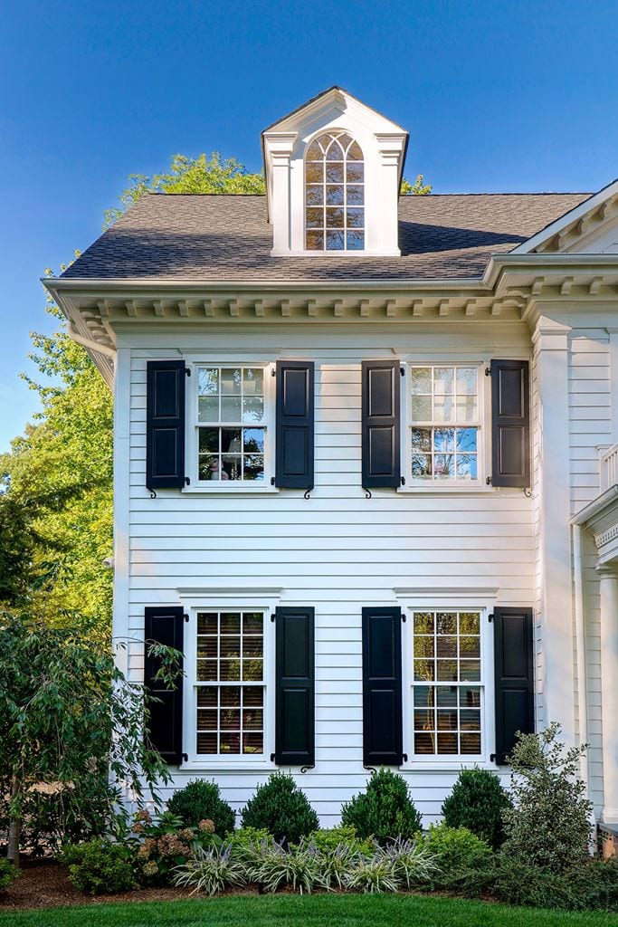 Classic white facade with double-hung windows and black shutters