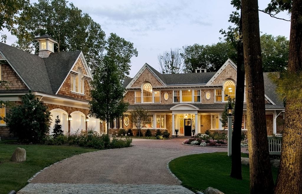 Large residence with double-hung windows, lit at dusk