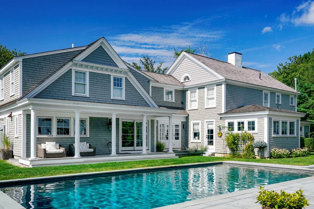Home with a pool and white double-hung windows