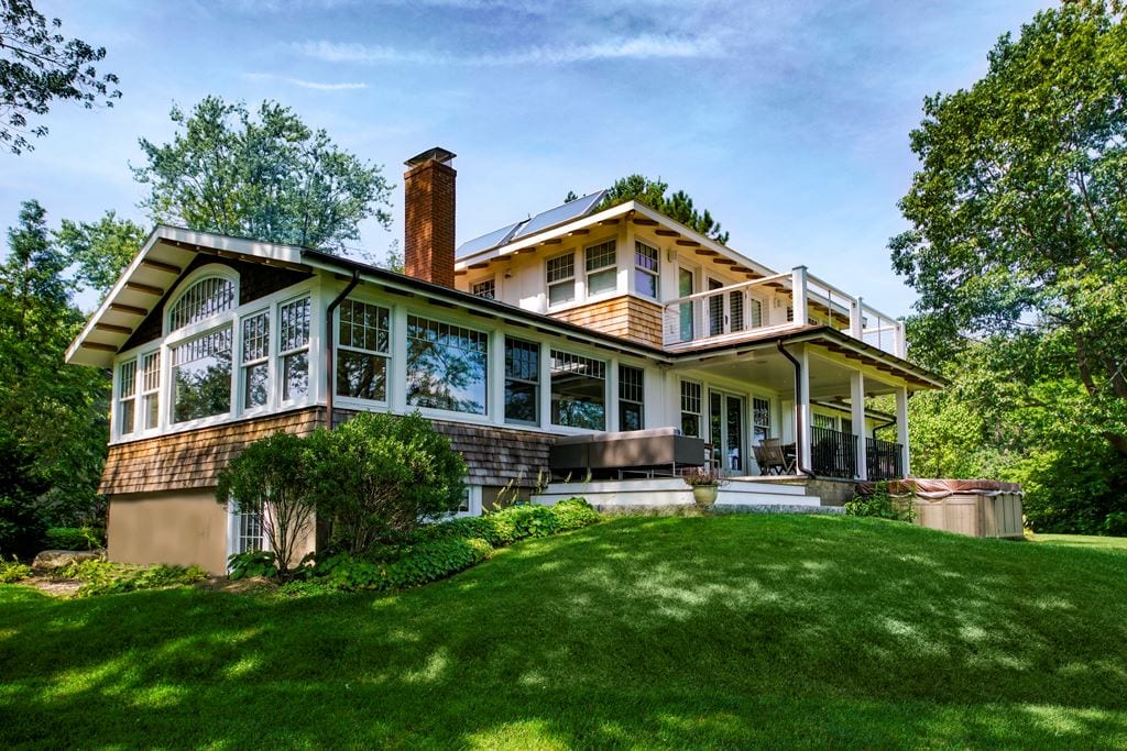 Country home with wood double-hung windows, seen from the garden