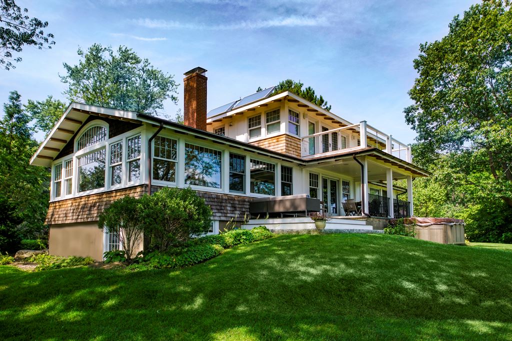 Country home with wood double-hung windows, seen from the garden