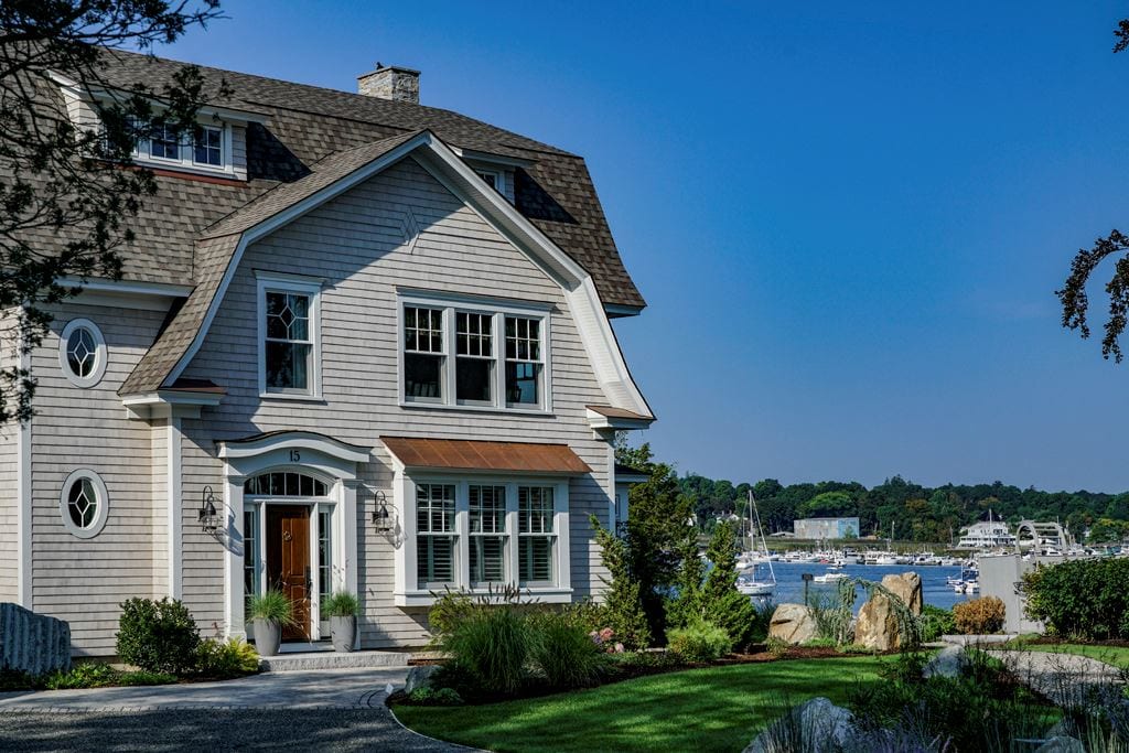 Shingled waterfront home with double-hung windows