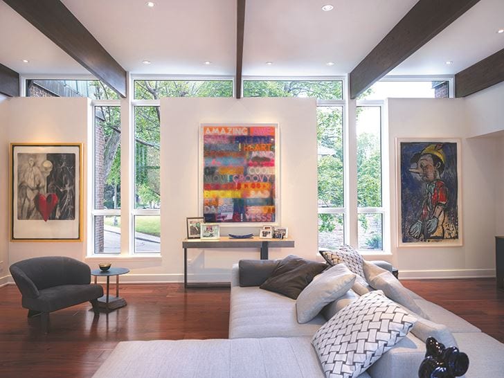 White fixed windows in a living room with artwork