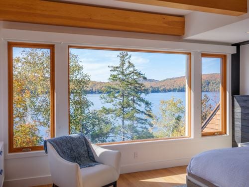 Wood-framed fixed window with a lake view