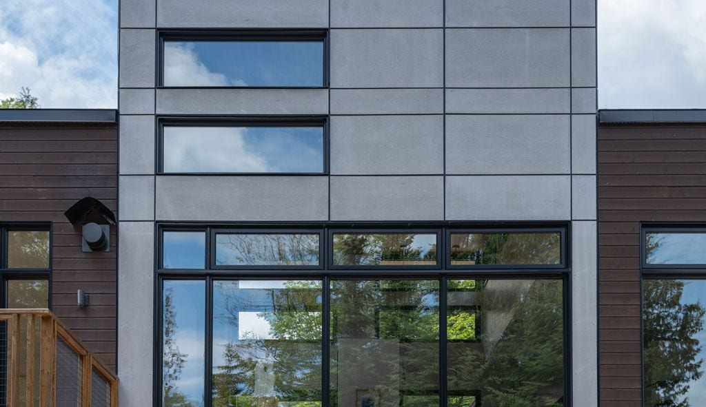 Modern grey facade with black-framed fixed windows