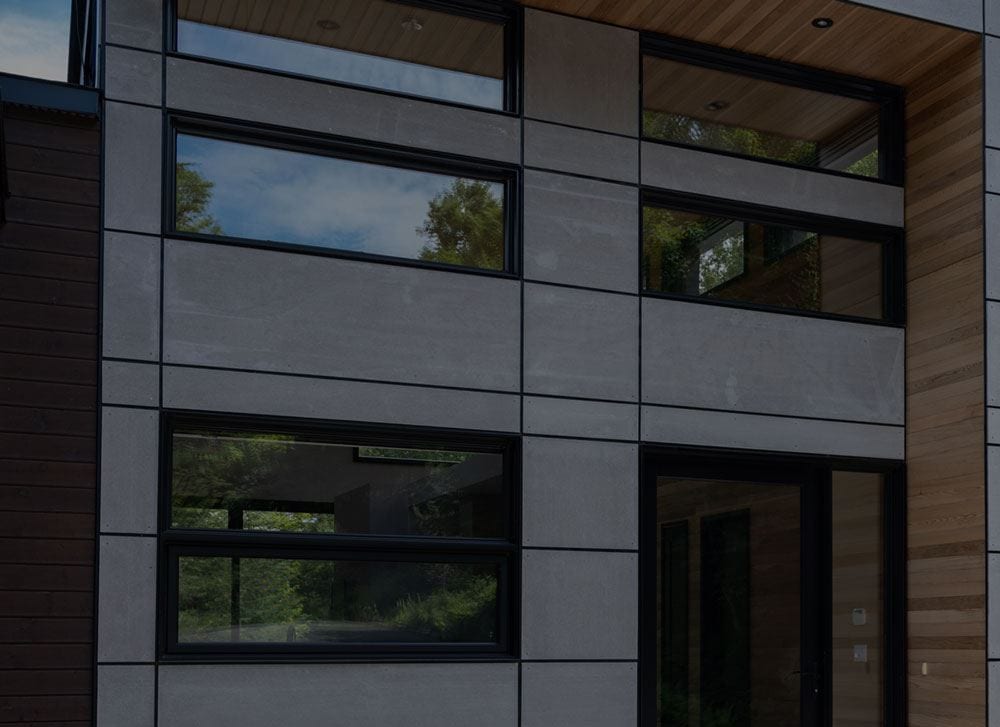 Contemporary facade with black-framed fixed windows