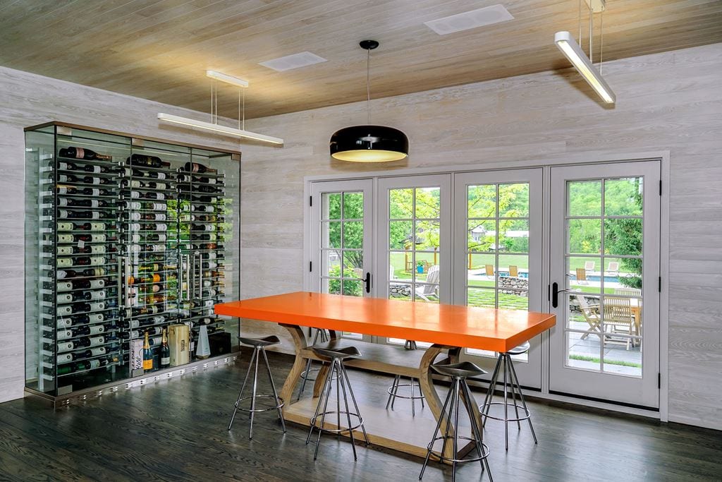 White French doors in a dining room with a glass wine cellar