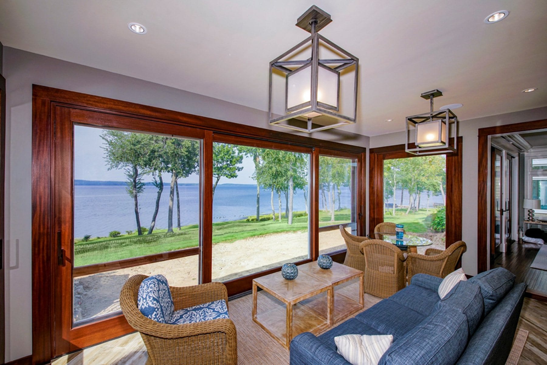 Wood lift and slide door opening onto a lake