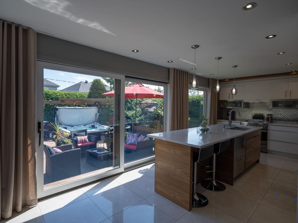 Large white lift and slide door between the kitchen and the terrace