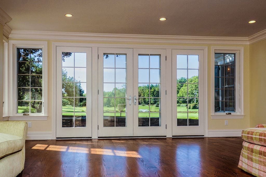 Large four-panel white French door with grilles
